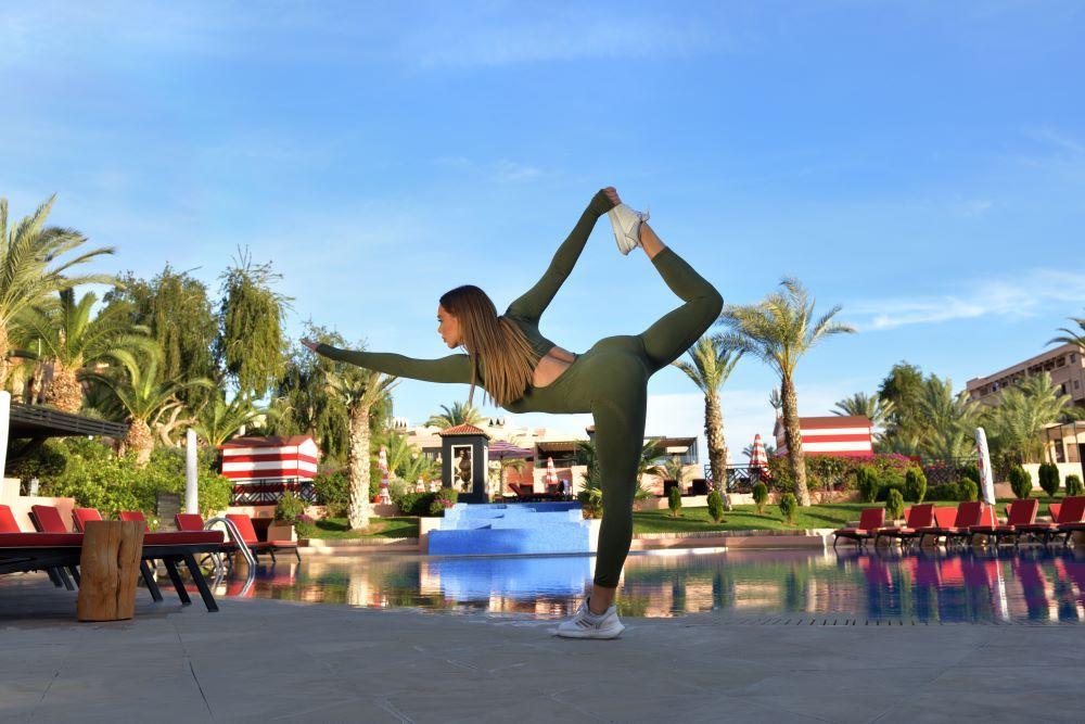 Moevenpick Hotel Mansour Eddahbi Marrakech Марракеш Экстерьер фото A woman practicing yoga
